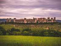The walled town of Monteriggioni sits dramatically in the Tuscan landscape |  Tim Charody