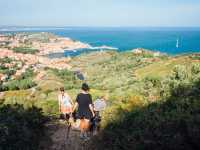 Hiking in the Eastern Pyrenees. Walk in the hills of Collioure. Holidays in the South of France. Walk with wind. Mediterranean panorama. Women hiking |  David Bise